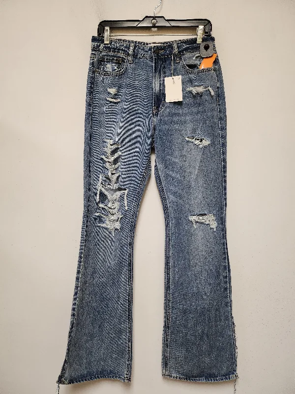 Ripped and repaired jeans for a rugged lookJeans Flared By Clothes Mentor In Blue Denim, Size: 6